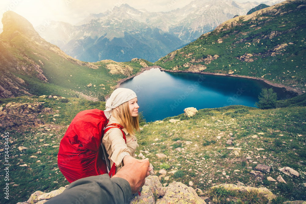 Young couple Woman with backpack holding Man hand following Travel hiking Lifestyle and relationship concept lake and mountains landscape on background