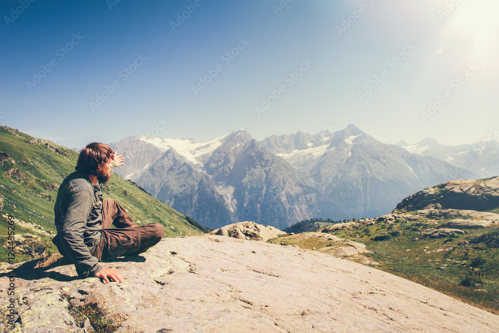 Man Traveler relaxing in mountains Travel Lifestyle concept scenic landscape on background summer vacations outdoor
