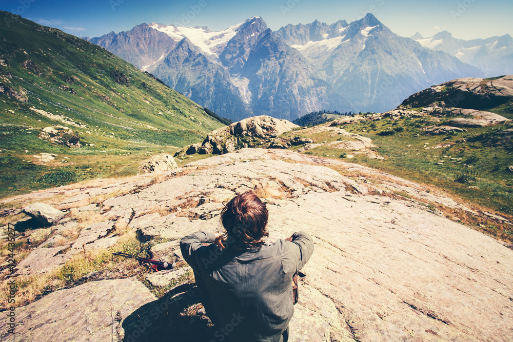 Fototapeta premium Traveler Man relaxing Travel Lifestyle concept beautiful mountains landscape on background adventure vacations outdoor rear view