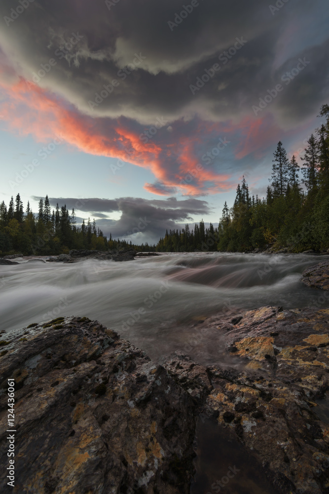 River landscape streaming down with heavy current at sunset River landscape streaming down with heavy current at sunset