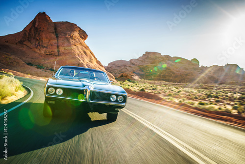 driving fast through desert in vintage hot rod car