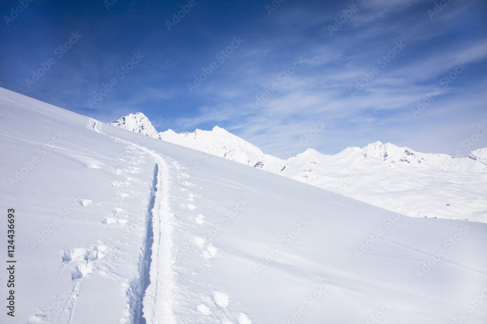 traces de pieds et de ski dans la neige en montagne