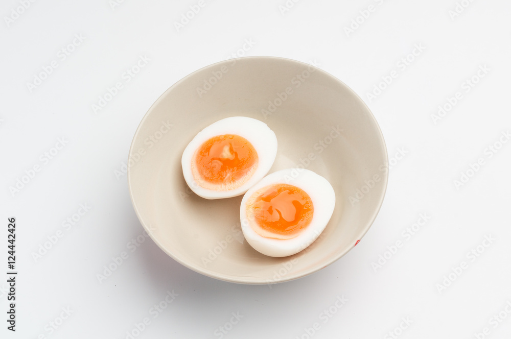 two halves of a boiled egg in a bowl two halves of a boiled egg in a bowl