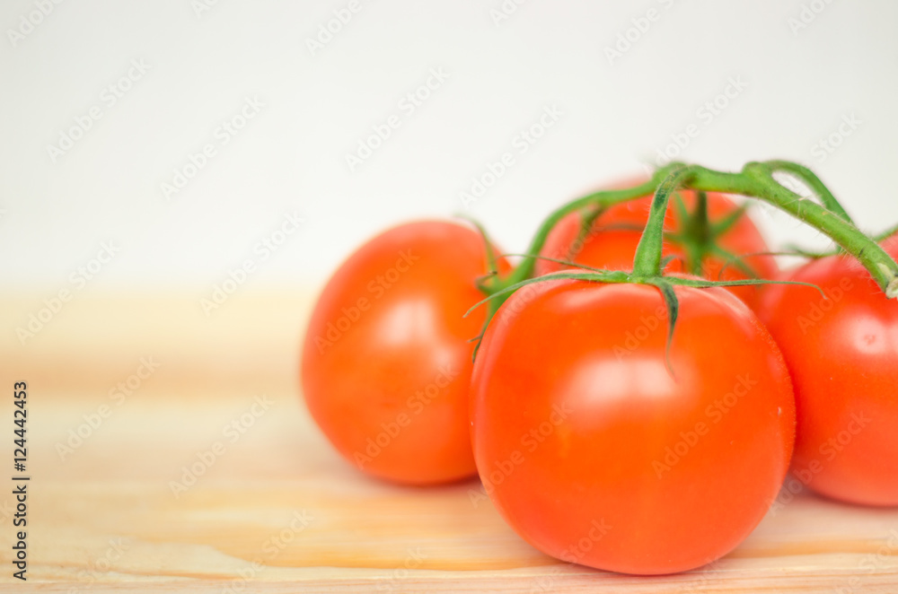 Close-up of fresh, ripe tomatoes on wood background. Close-up of fresh, ripe tomatoes on wood background.