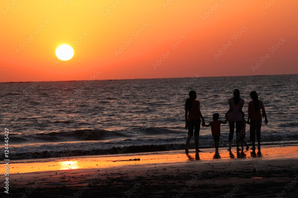 family walking together on a beach