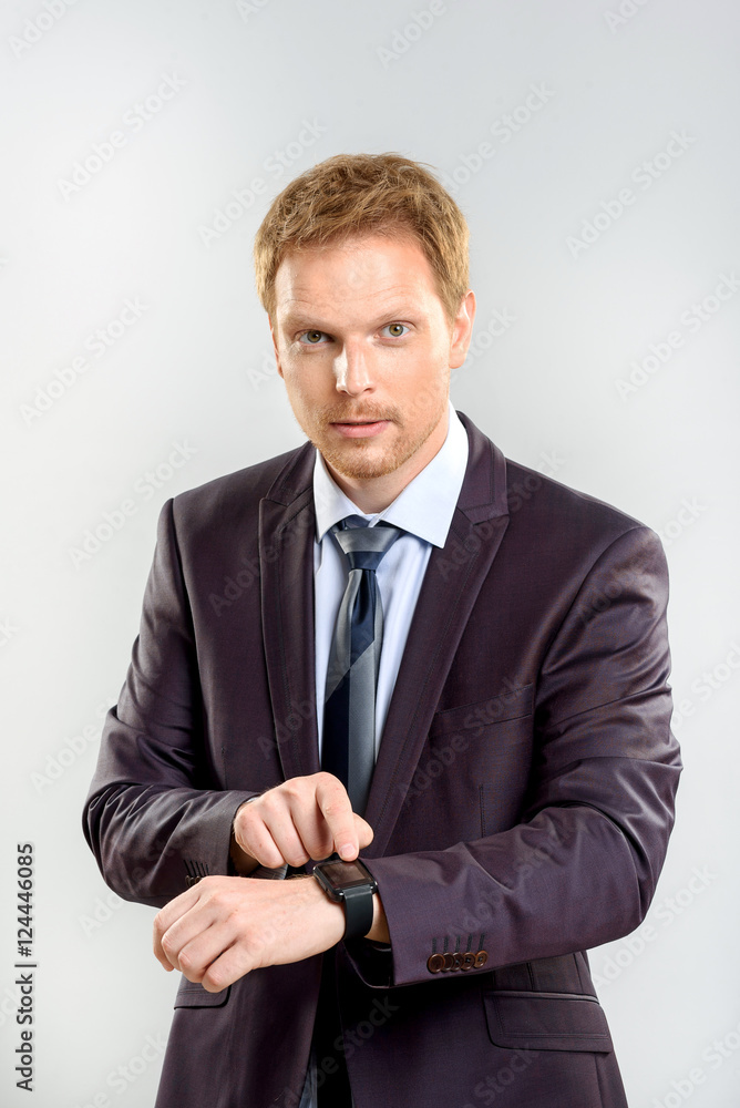successful businessman pointing his finger at the watch successful businessman pointing his finger at the watch