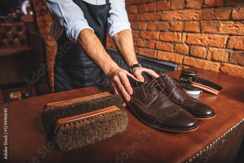 shoemaker holding a pair of brand new shoes photo