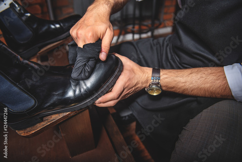 old shoemaker cleansing the footwear