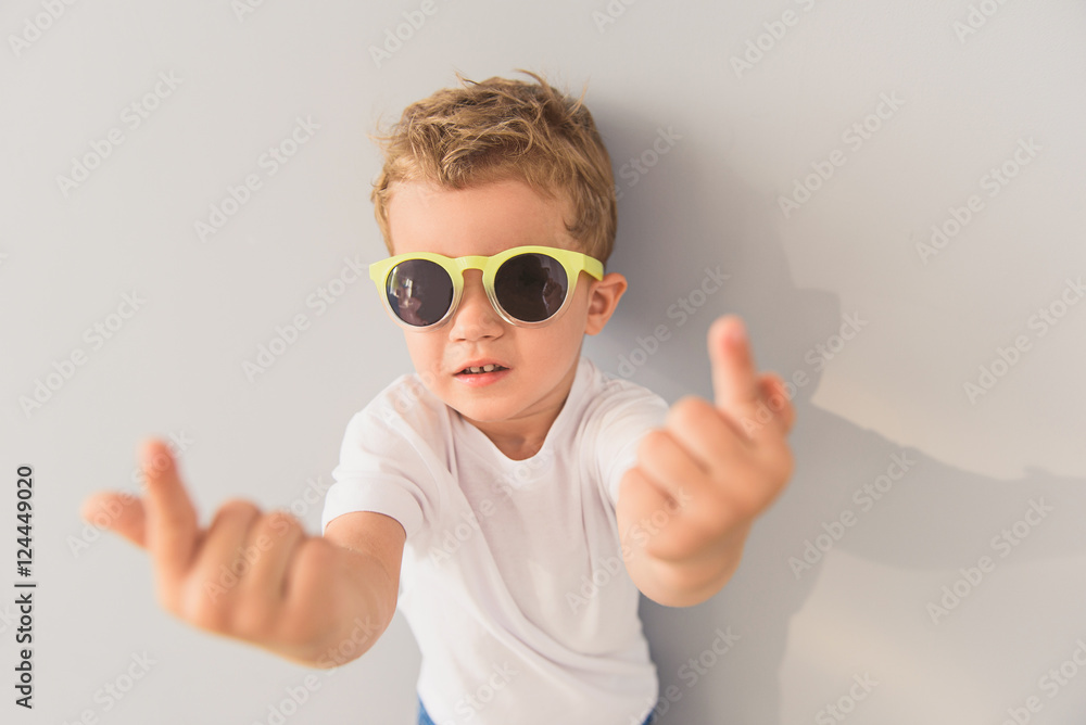 Little boy in sunglasses posing in studio Little boy in sunglasses posing in studio