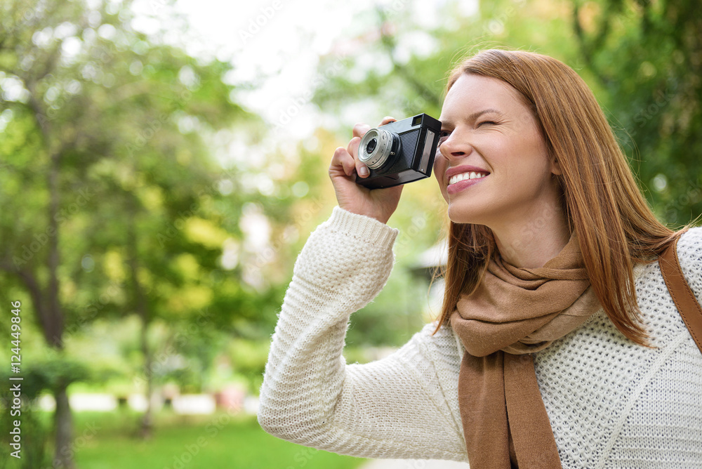 Cheerful girl photographing beautiful nature Cheerful girl photographing beautiful nature