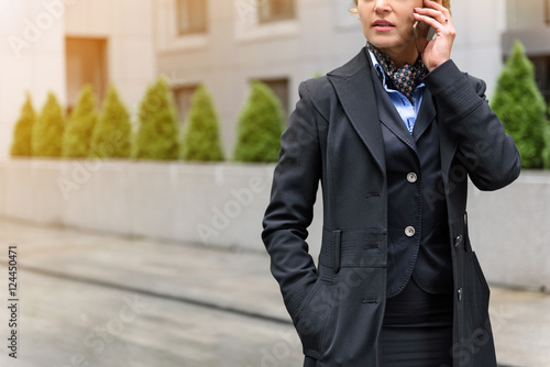 Confident businesswoman using smartphone for communication