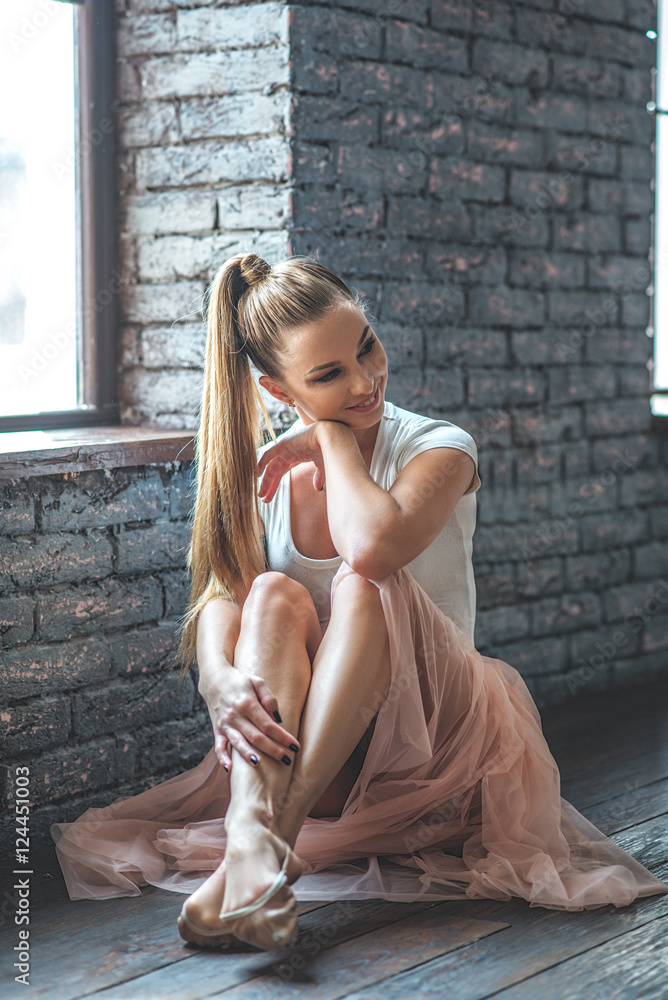 Young dancer sitting in dance studio