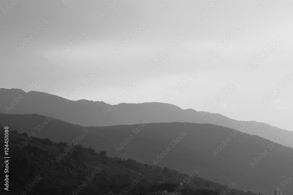 Fototapeta premium Black and white landscape with mountains, sky and fog