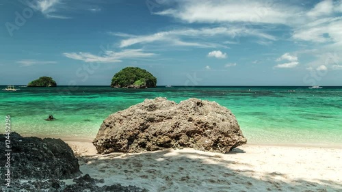 Tourist boat sails on the azure beach. 4K TimeLapse - August 2016, Boracay, Philippines photo