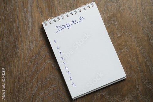 things to do list on notepad on wood table