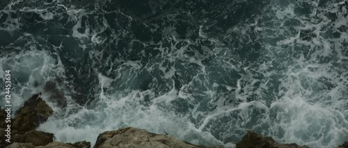 Cinematic slow motion 14-bit RAW footage of sea waves crashing into rocks. Dubrovnik. Croatia. Early autumn.