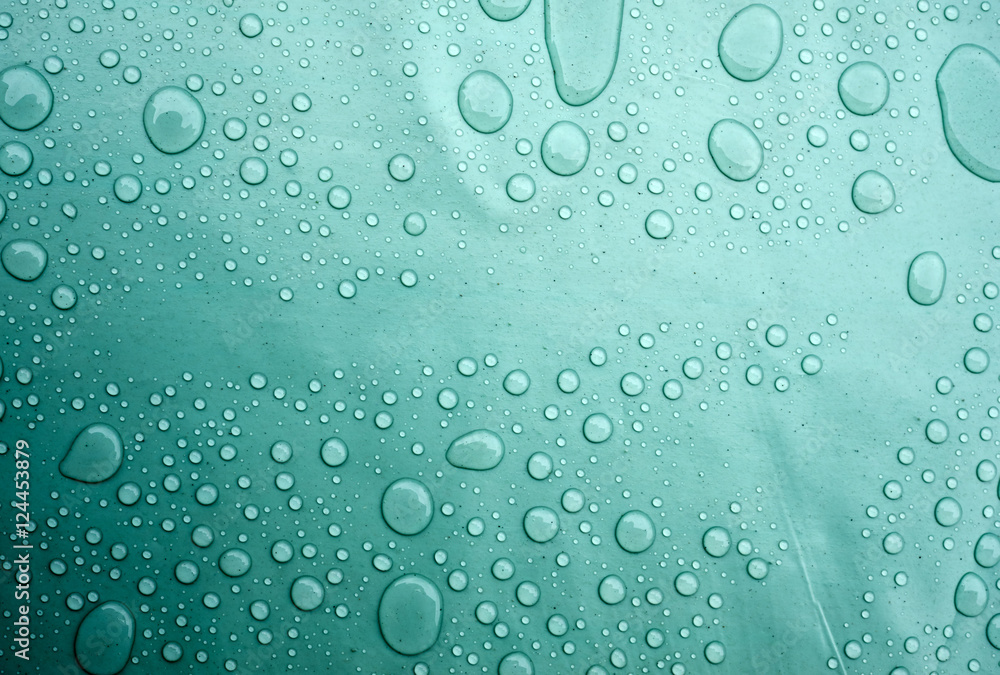 Drops of water on a dusty green color background. Shallow depth of field. Selective focus. Toned. Drops of water on a dusty green color background. Shallow depth of field. Selective focus. Toned.