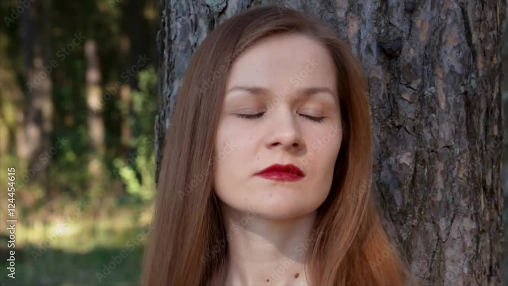 Serious sad stylish girl with red lips looking from side to side on a sunny. Serious sad stylish girl with red lips looking from side to side on a sunny.