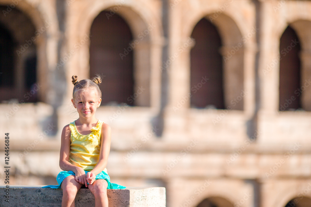Adorable little girl background of Colosseum in Rome, Italy. Kid spending holiday in Europe