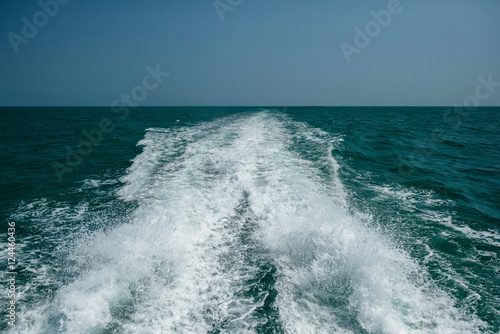 Acting wave behind motor boat
