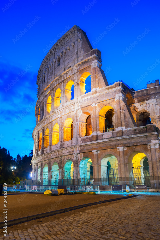 view of Colosseum facade close up illuminated at night in Rome, Italy, vertical shot