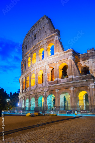 Photography view of Colosseum facade close up illuminated at night in Rome, Italy, vertical