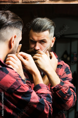 man with razor near mirror