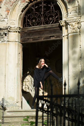 fashionable woman near old building