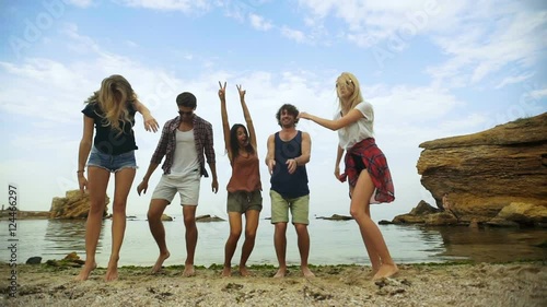 Friends jumping on the beach.