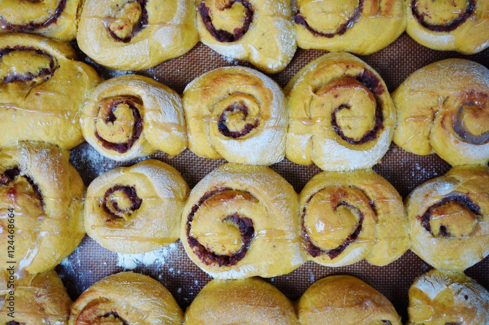 Tray of freshly baked vegan pumpkin cinnamon rolls Tray of freshly baked vegan pumpkin cinnamon rolls