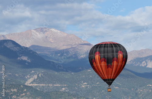 Colorful hot Air Balloon flying over Pikes Peak, Colorado Spring
