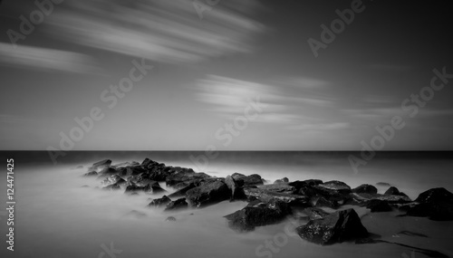 rocky jetty with calm ocean