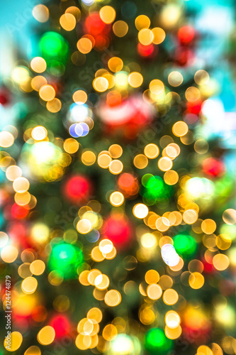 Background of christmas tree with bokeh lights and defocused xmas balls.