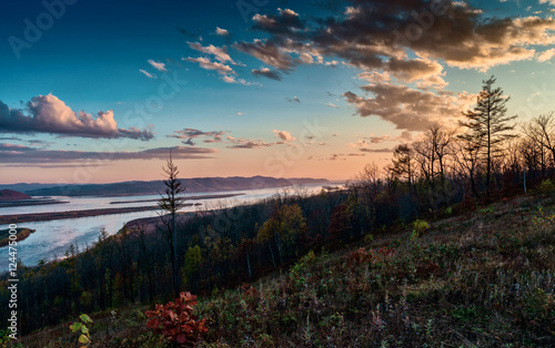 Sunset over the Amur river in late autumn. Autumn Evening on the river.