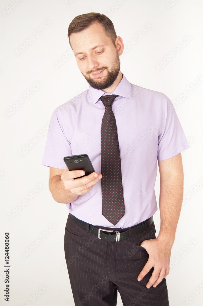 Happy smiling caucasian business man looking at smartphone, isolated on white background Happy smiling caucasian business man looking at smartphone, isolated on white background