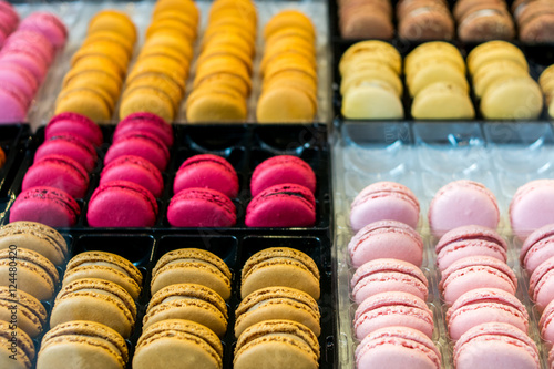 traditional French colorful macaroons in a rows in a box. Prepare to display for sale on shelf at bakery shop