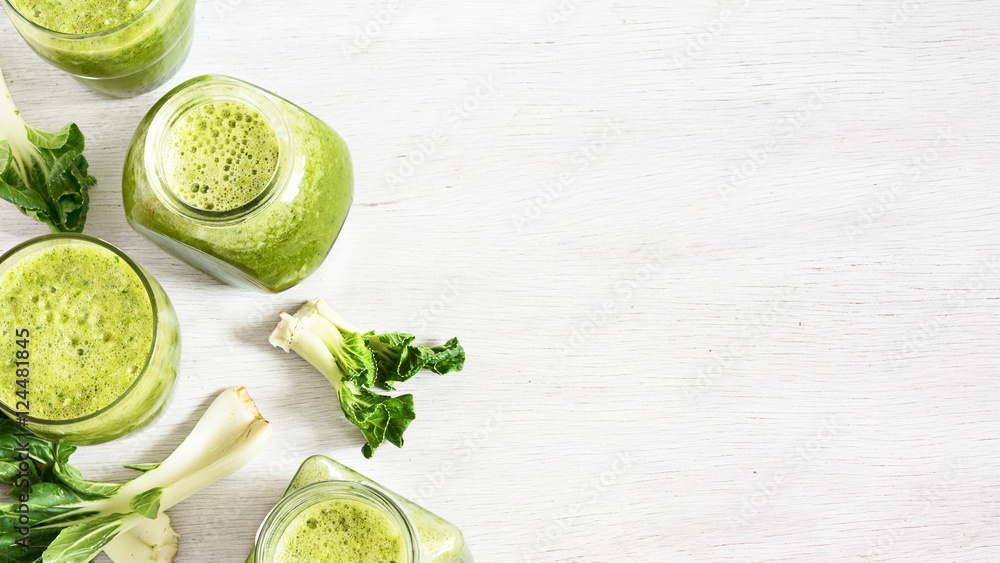 Obraz premium Green vegetable smoothie in jars. Green detox. Healthy food concept.