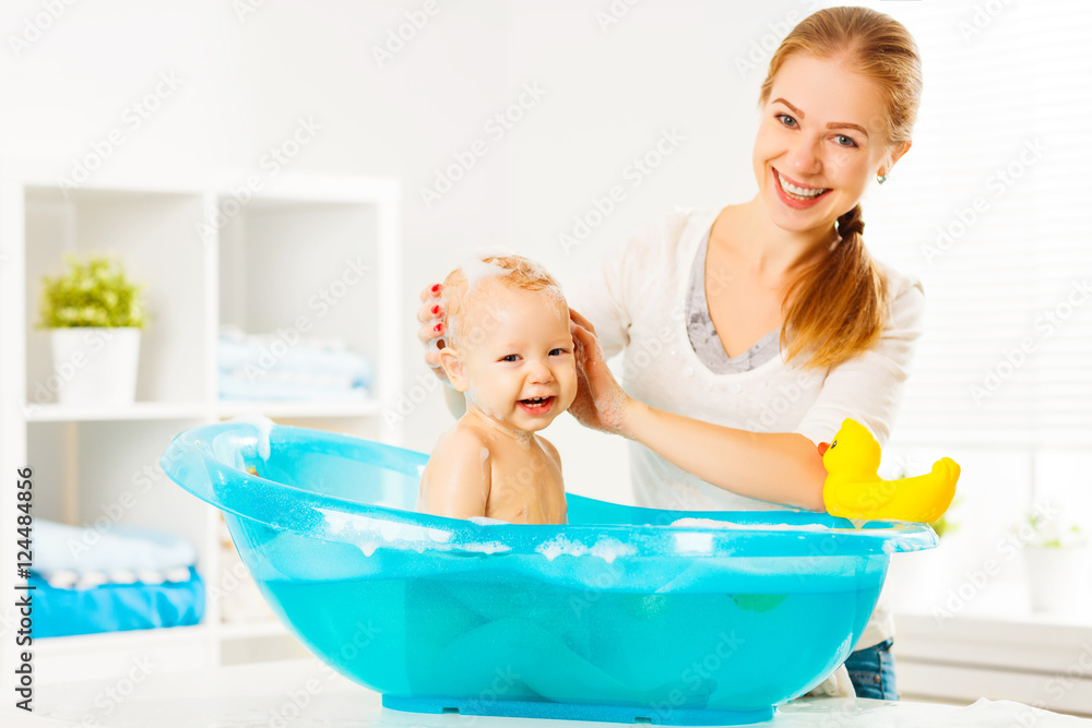 Happy family mother bathes the baby in bath Stock Photo | Adobe Stock