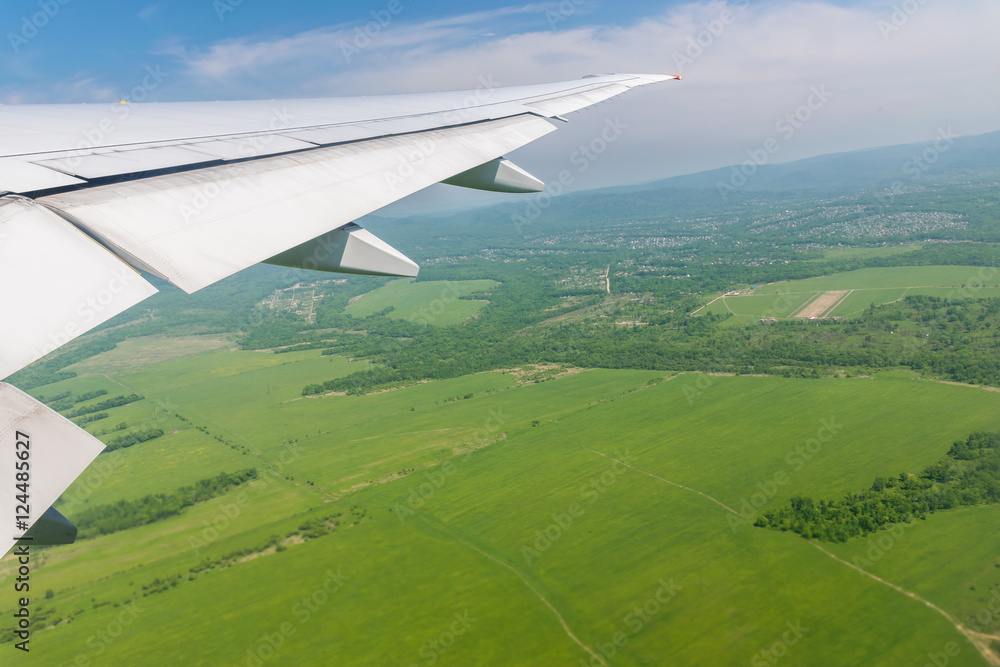 View from plane on Earth surface with wing of an airplane. Suburb. View from plane on Earth surface with wing of an airplane. Suburb.