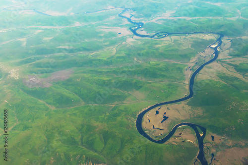 View from airplane on Earth surface - river. With some hot air effect.