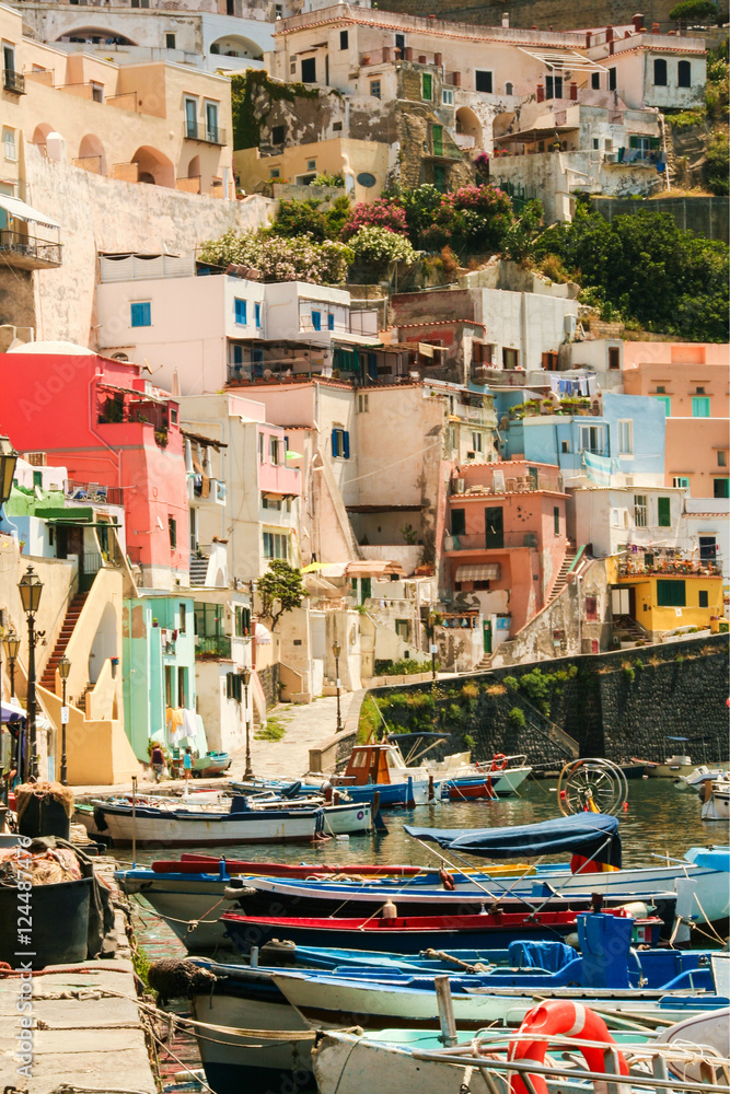 the charming port of Corricella with its colorful fishermen's houses and boats, Island of  Procida, Naples, Italy