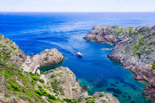 Ship at Cap de Creus, cape in Cadaques, Girona, Catalonia, Spain. The most eastern point of Spain and the Iberian Peninsula. Mediterranean coastline.