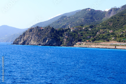 Rocky coast and Cinque Terre village Corniglia and Mediterranean Sea, Italy