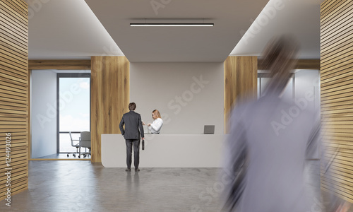 Woman and two men in company corridor