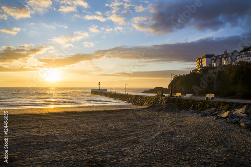 Sunrise at Looe beach with clouds in the sky and golden colours  Cornwall  UK