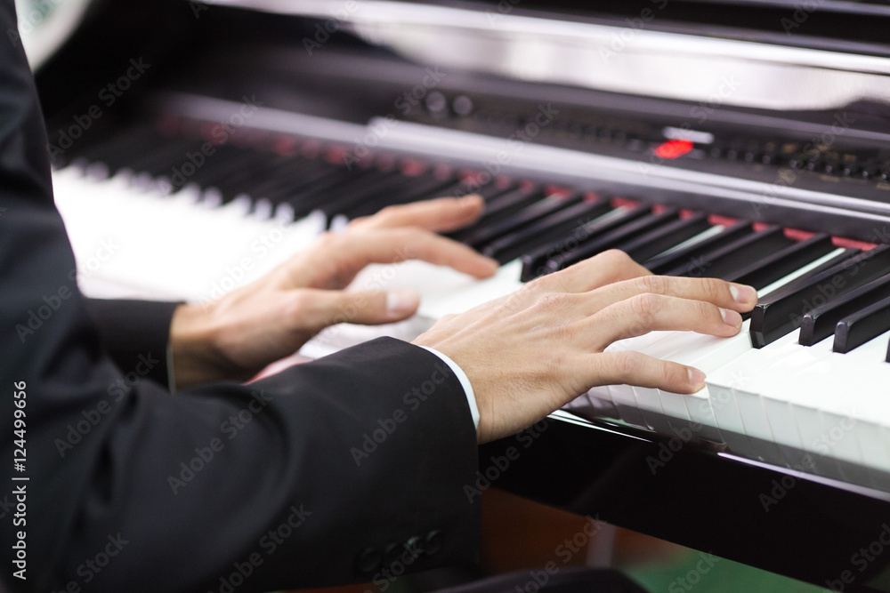 Obraz premium hands of the man playing the piano. pianist's hands close up.