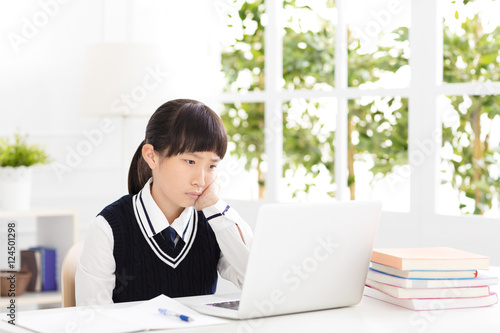 Worried and stress teenager student studying with laptop