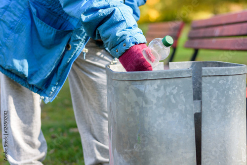 Person scrounging through a bin