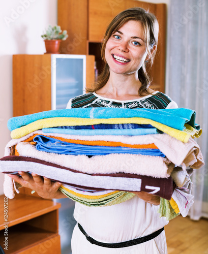 Cheerful beautiful woman with colorful towels photo