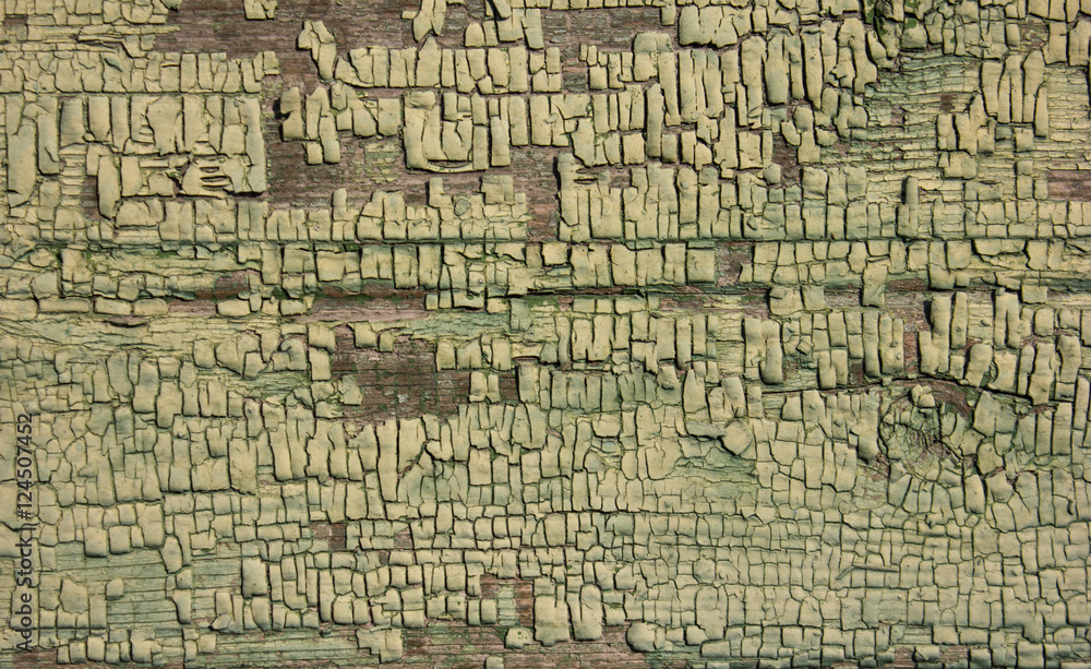 green ochre shade coloured cracked paint peeling on wood texture.